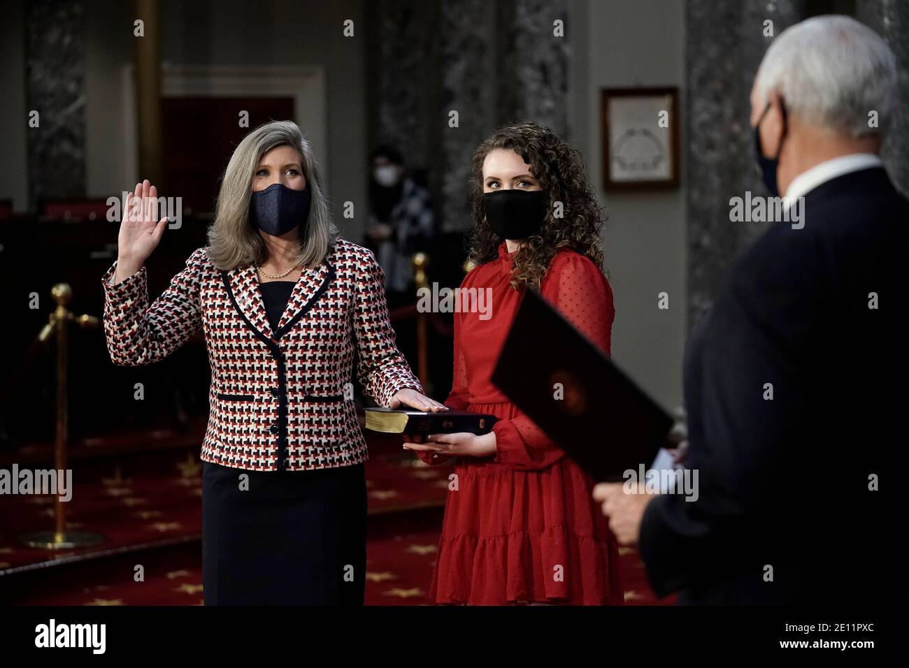 Washington, USA. 03rd Jan, 2021. Vice President Mike Pence administers the oath of office to Sen. Joni Ernst, R-Iowa, left, joined by her daughter Libby Ernst, during a reenactment ceremony in the Old Senate Chamber at the Capitol in Washington, Sunday, Jan. 3, 2021. (Photo by J. Scott Applewhite/Pool/Sipa USA) Credit: Sipa USA/Alamy Live News Stock Photo