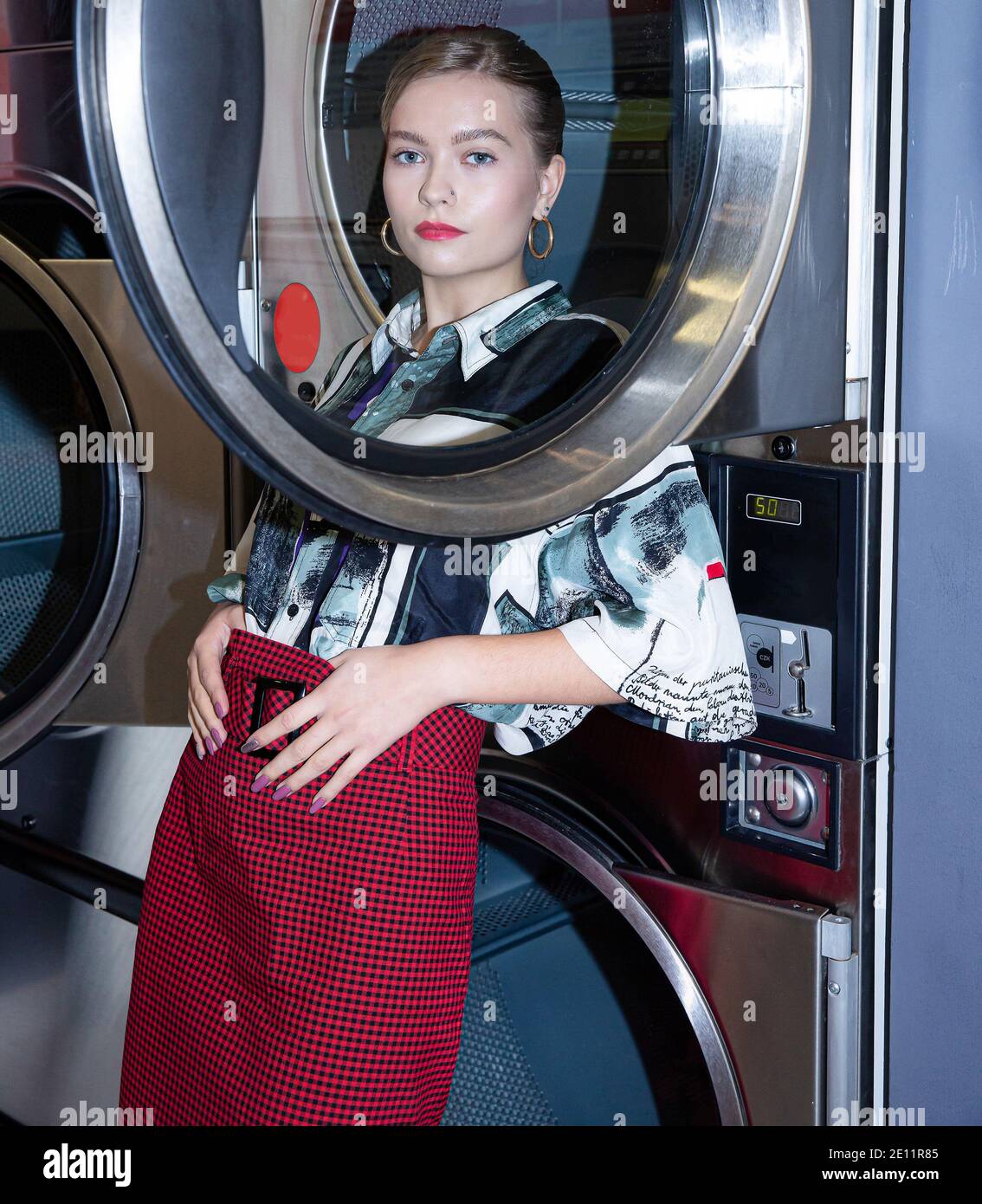 Reflection of white girl model portrait with washing machine Stock Photo