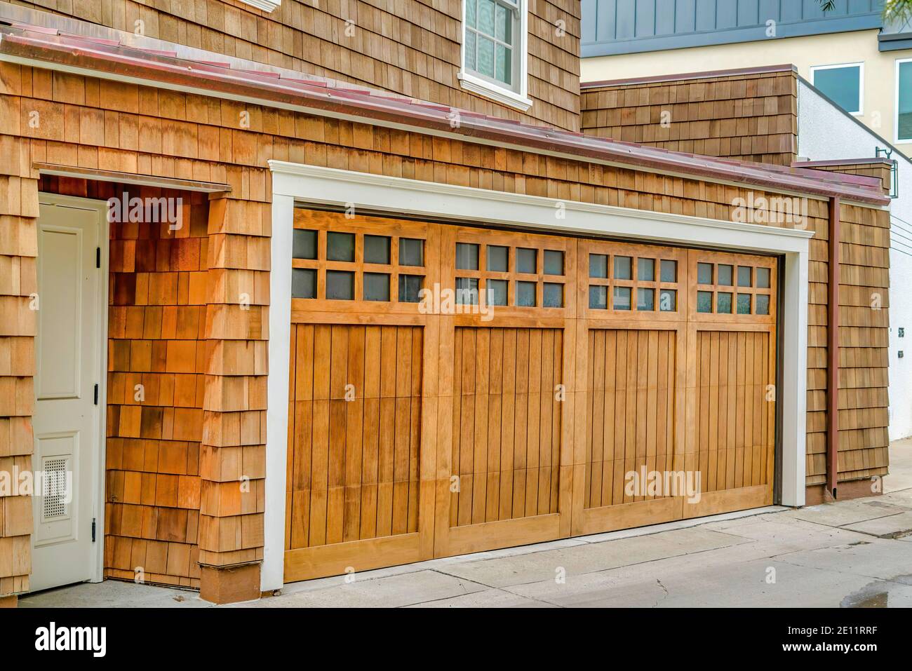 Facade of home in Long Beach with white front door and glass paned