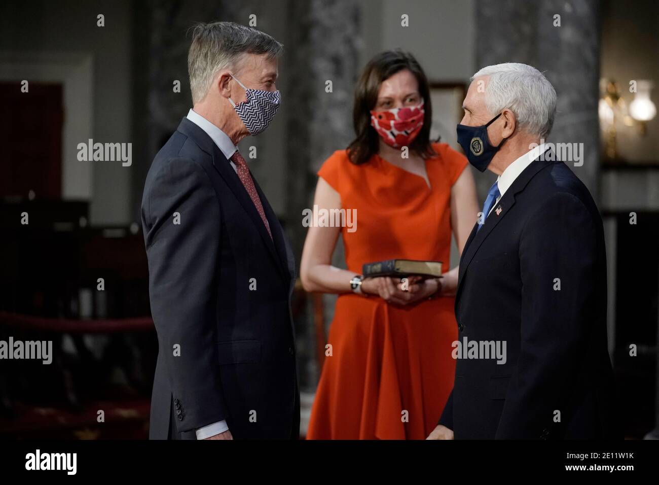 Washington, USA. 03rd Jan, 2021. Sen. John Hickenlooper, D-Colo., left, joined by his wife Robin Pringle Hickenlooper, greets Vice President Mike Pence as he takes the oath of office during a reenactment ceremony in the Old Senate Chamber at the Capitol in Washington, Sunday, Jan. 3, 2021. (Photo by J. Scott Applewhite/Pool/Sipa USA) Credit: Sipa USA/Alamy Live News Stock Photo