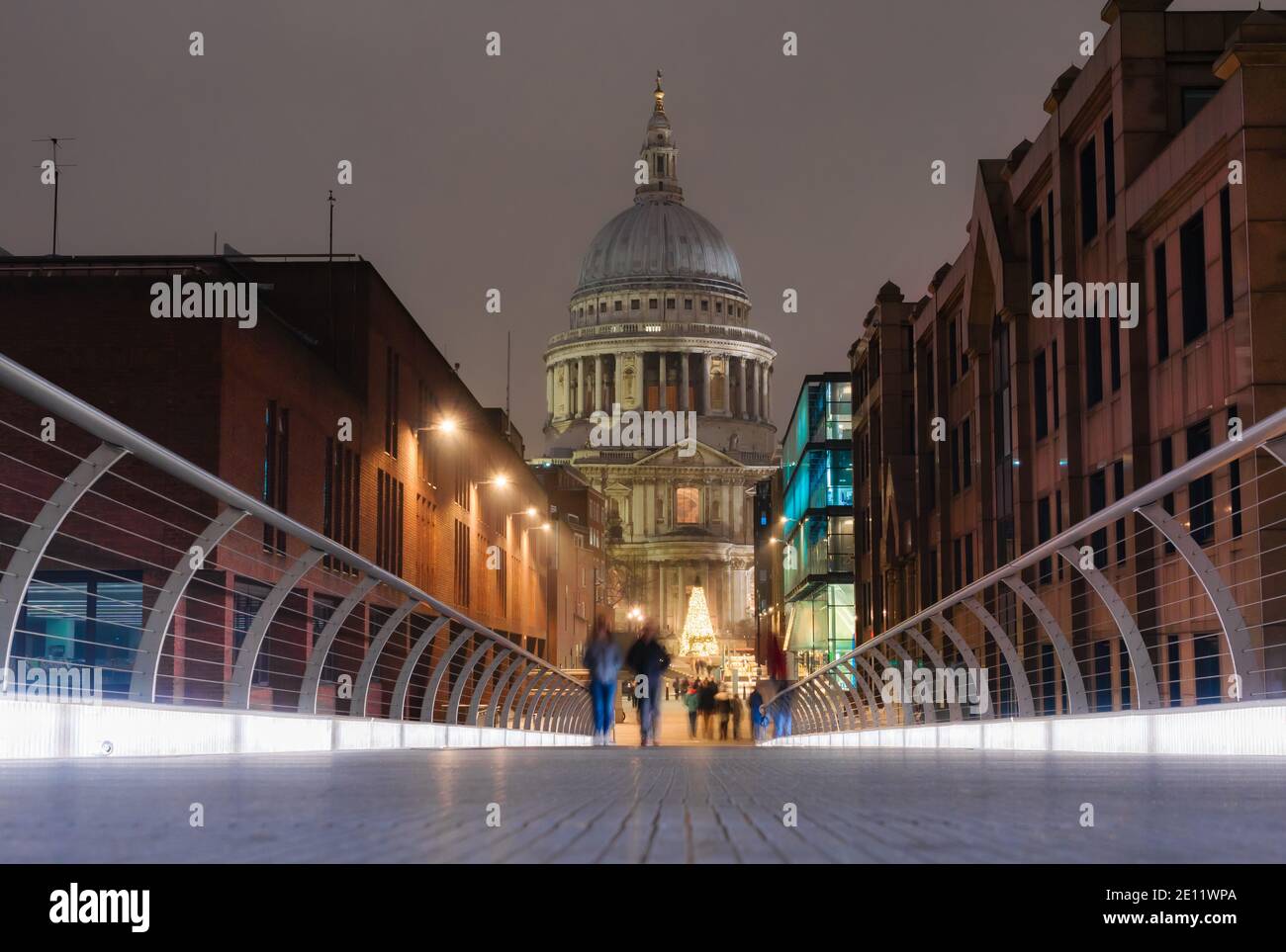 View from the Millennium Bridge of the Saint Paul’s Cathedral in the city of London illuminated at dusk Stock Photo