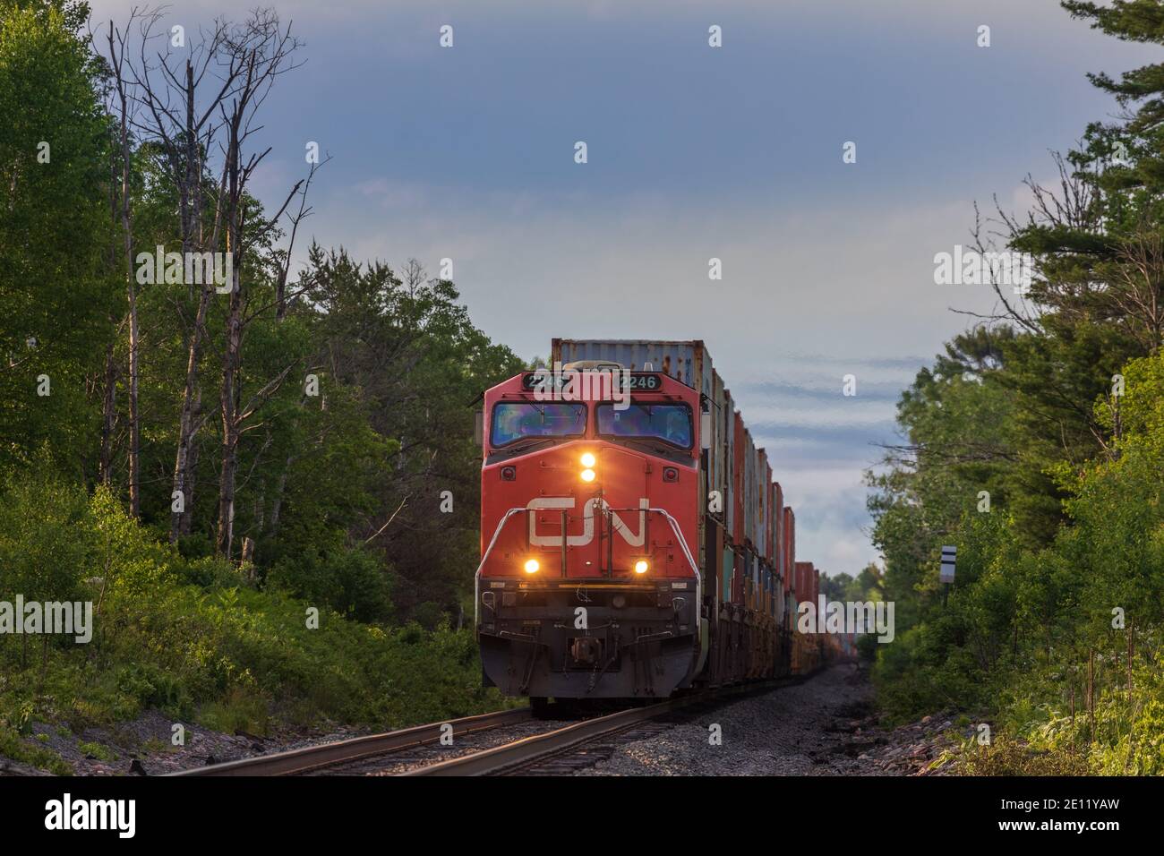 Canadian National freight train passing through a farming community in Exeland, Wisconsin. Stock Photo