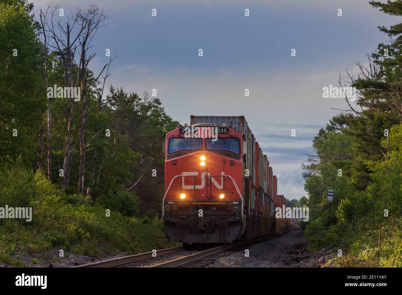 Canadian National freight train passing through a farming community in Exeland, Wisconsin. Stock Photo