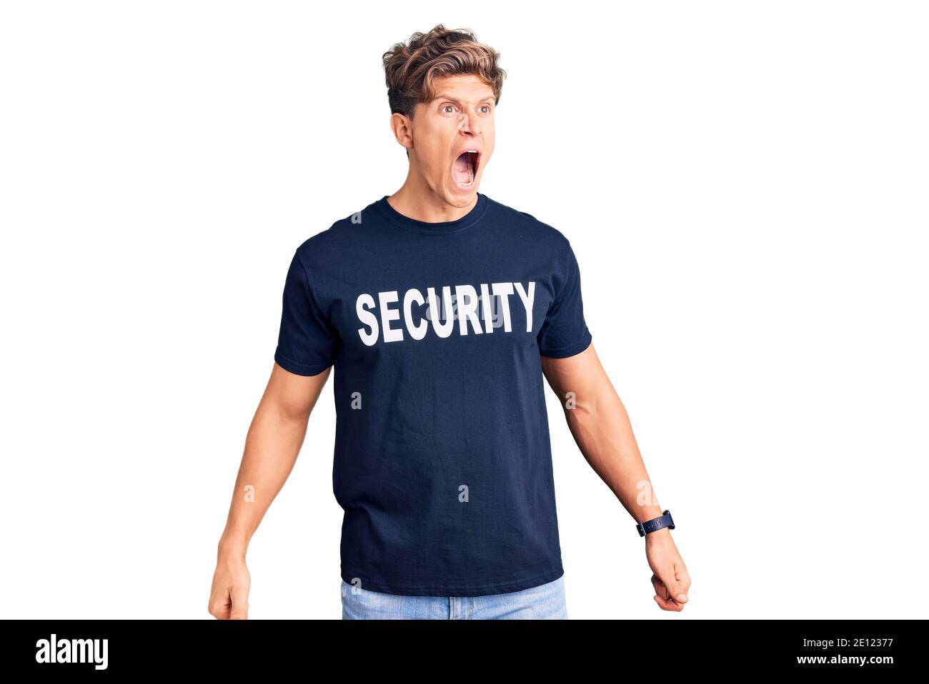 Young handsome man wearing security t shirt angry and mad screaming ...