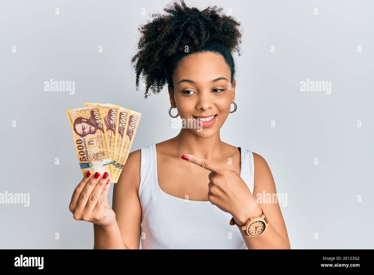 Young African American Girl Holding 5000 Hungarian Forint Banknotes young-african-american-girl-holding-5000-hungarian-forint-banknotes