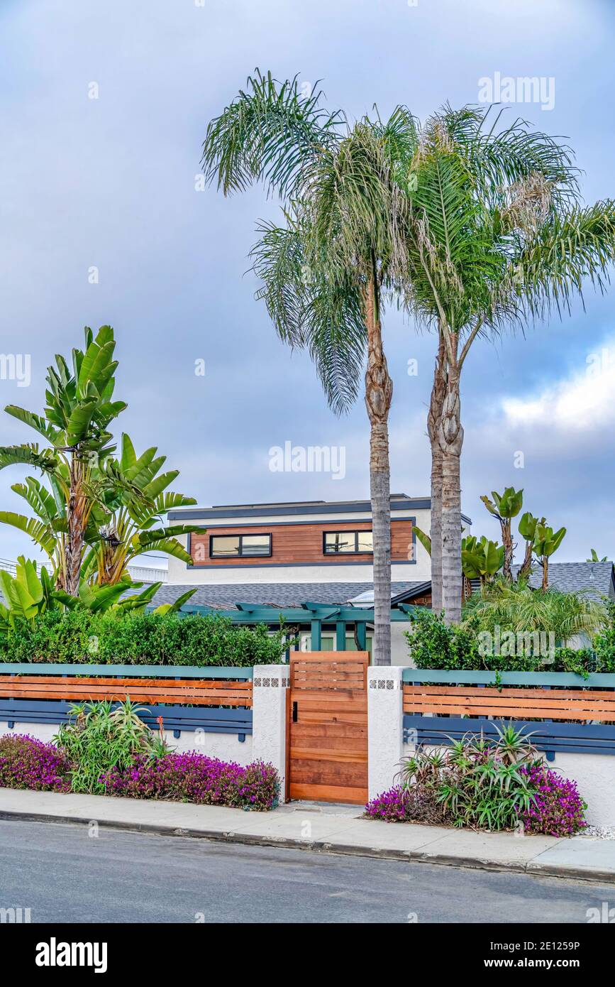 Wooden gate and fence of home in San Diego California against cloudy ...