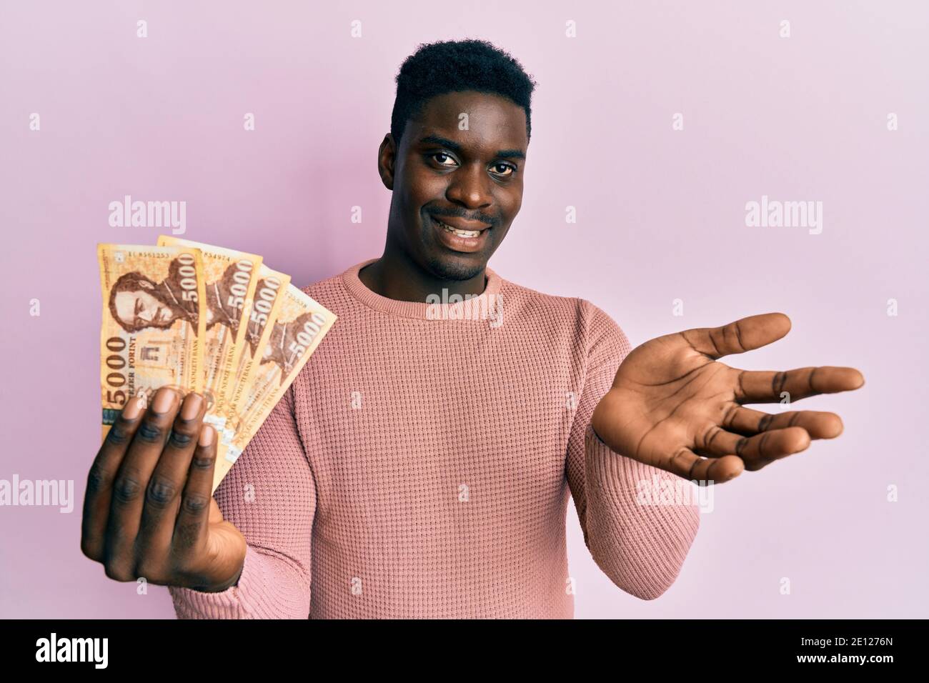 Handsome Black Man Holding 5000 Hungarian Forint Banknotes Celebrating handsome-black-man-holding-5000-hungarian-forint-banknotes-celebrating
