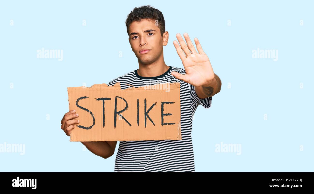 Strike Sign Man Young handsome african american man holding strike banner cardboard ...