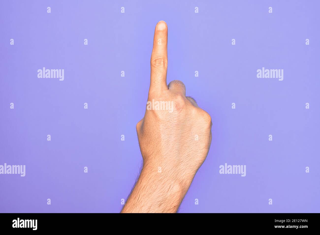 Hand of caucasian young man showing fingers over isolated purple ...