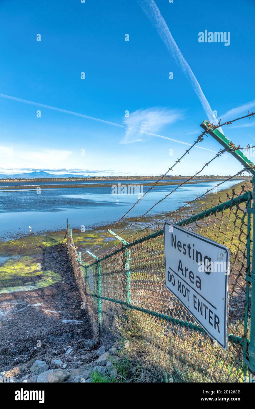 Nesting Area Do Not Enter sign on chain link fence in Bolsa Chica Nature  Reserve Stock Photo - Alamy