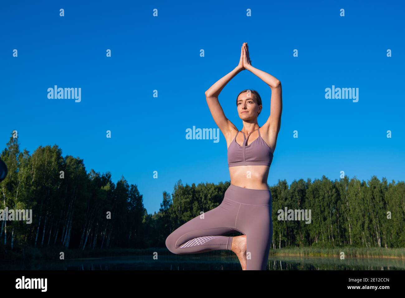 Girl doing yoga tree pose in nature. Girl yoga pose. Sports outdoors ...
