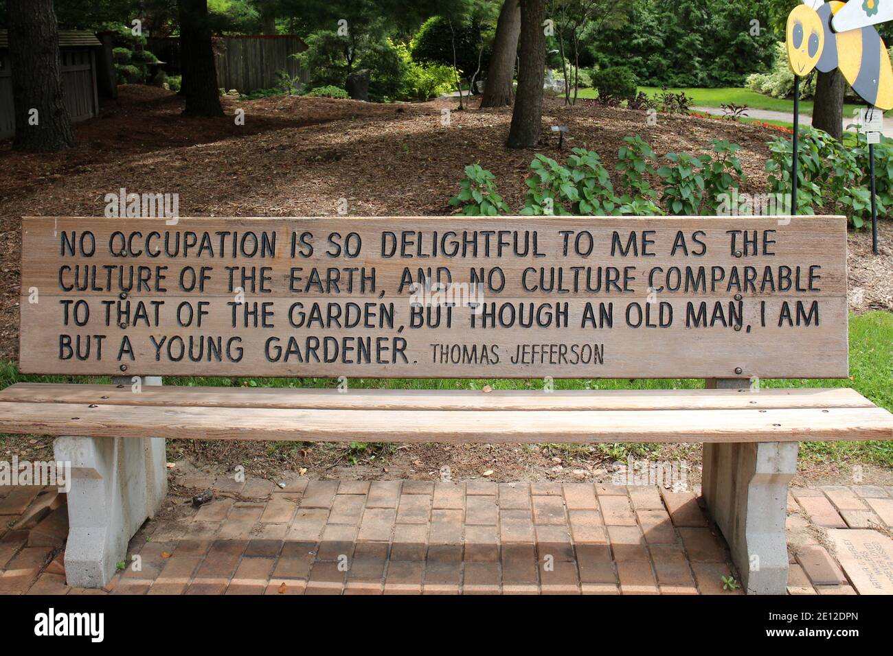 A park bench with an engraved quote by Thomas Jefferson on a brick ...