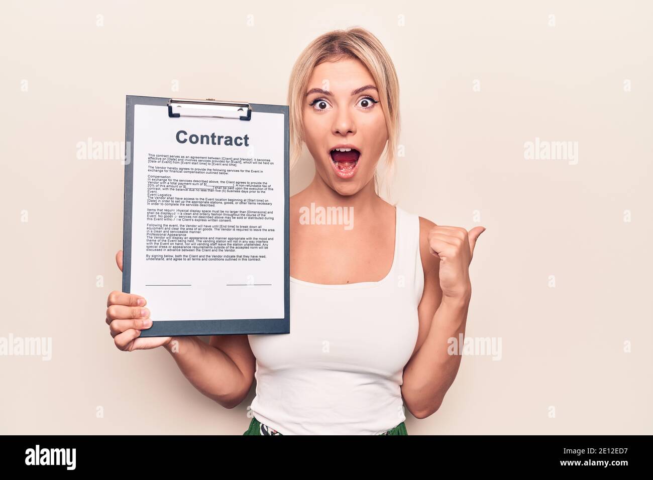Beautiful blonde woman holding clipboard with contract document paper ...