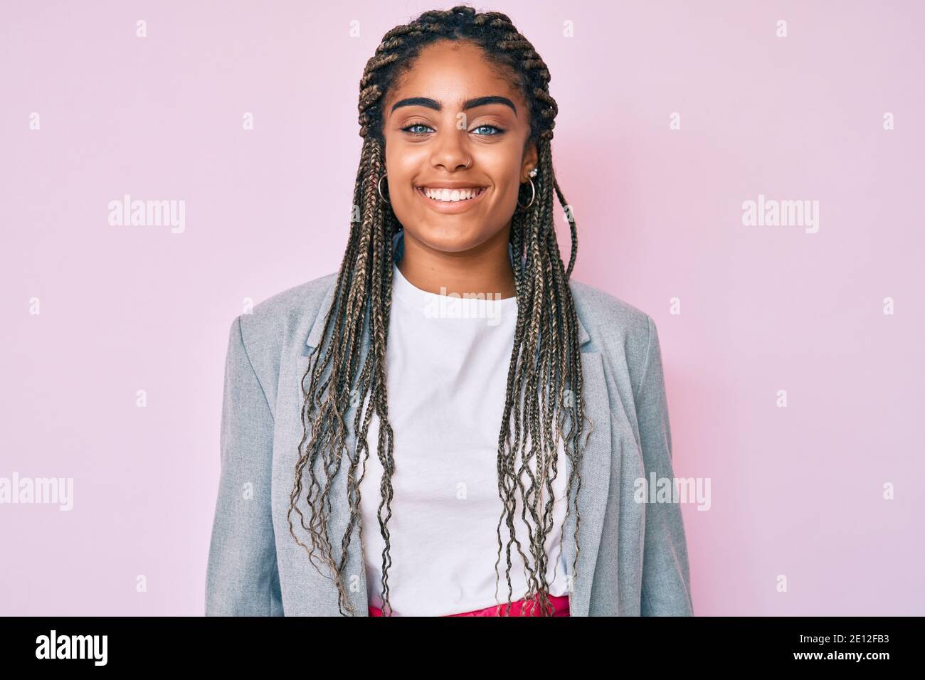Young african american woman with braids wearing business jacket ...