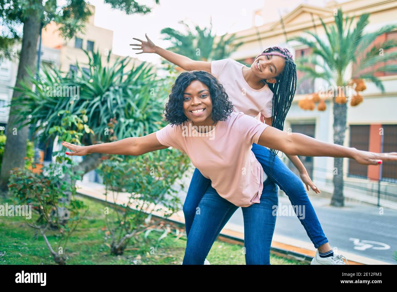 Couple playing piggyback ride in park Stock Photo - Alamy