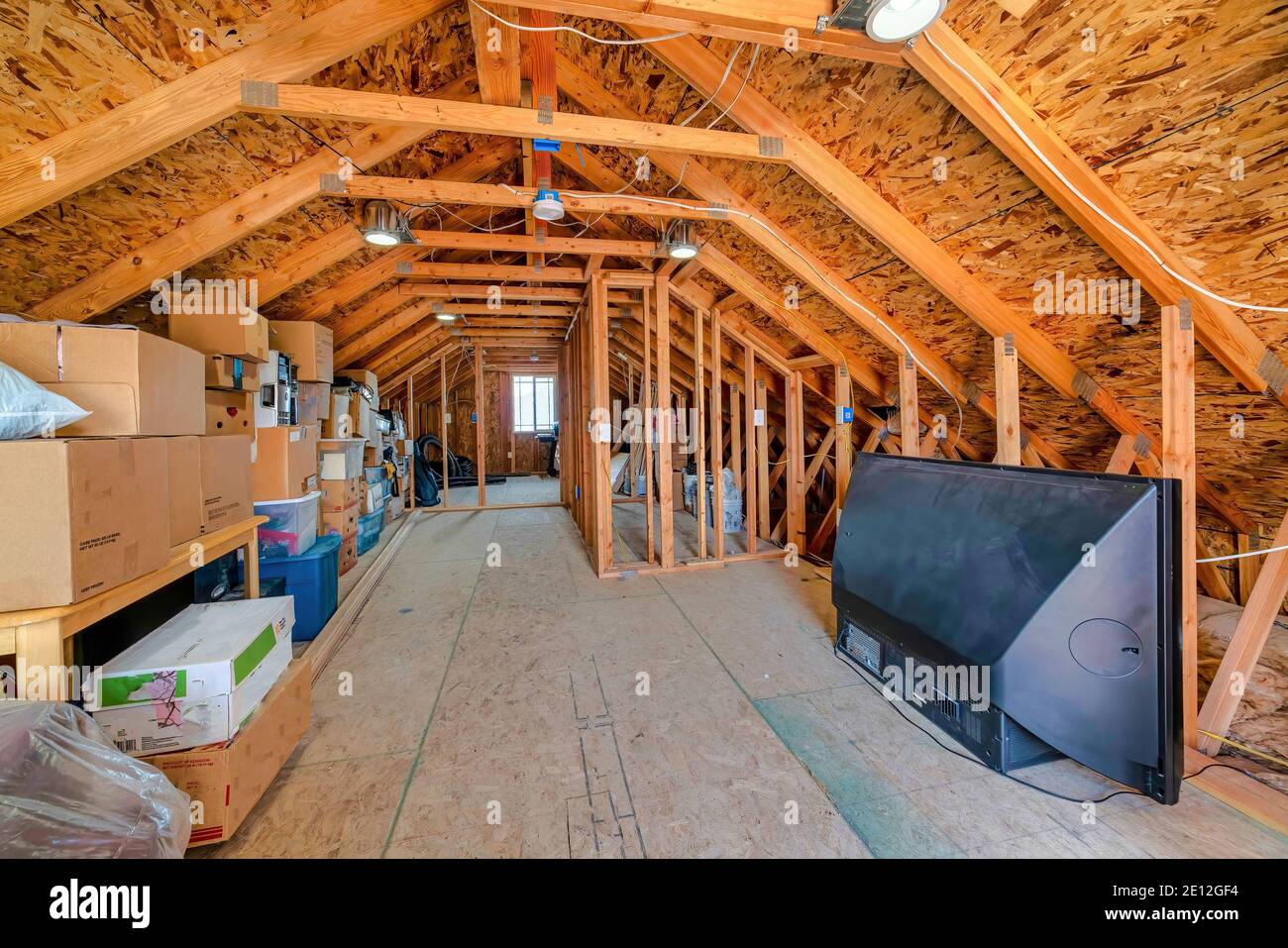 Interior of the attic of house with boxes and old appliances under