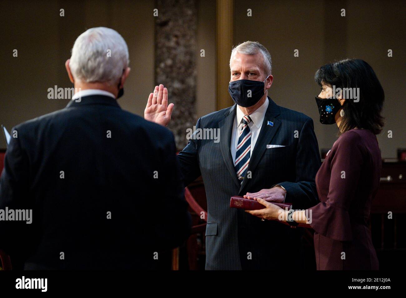 United States Vice President Mike Pence administers the oath of office to US Senator Dan Sullivan (Republican of Alaska) and his wife Julie Fate, during a mock swearing-in ceremony in the Old Senate Chamber on Capitol Hill on January 3, 2021 in Washington, DC. Credit: Pete Marovich/Pool via CNP/MediaPunch Stock Photo