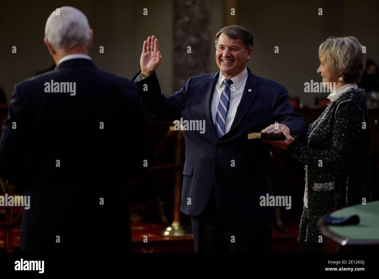 United States Senator Mike Rounds (Republican of South Dakota), center, smiles while being ceremoniously sworn-in by U.S. Vice President Mike Pence, left, at the U.S. Capitol in Washington, DC, U.S., on Sunday, Jan. 3, 2021. The 117th Congress begins today with the election of the speaker of the House and administration of the oath of office for lawmakers in both chambers, procedures that will be modified to account for Covid-19 precautions. Credit: Samuel Corum/Pool via CNP/MediaPunch Stock Photo