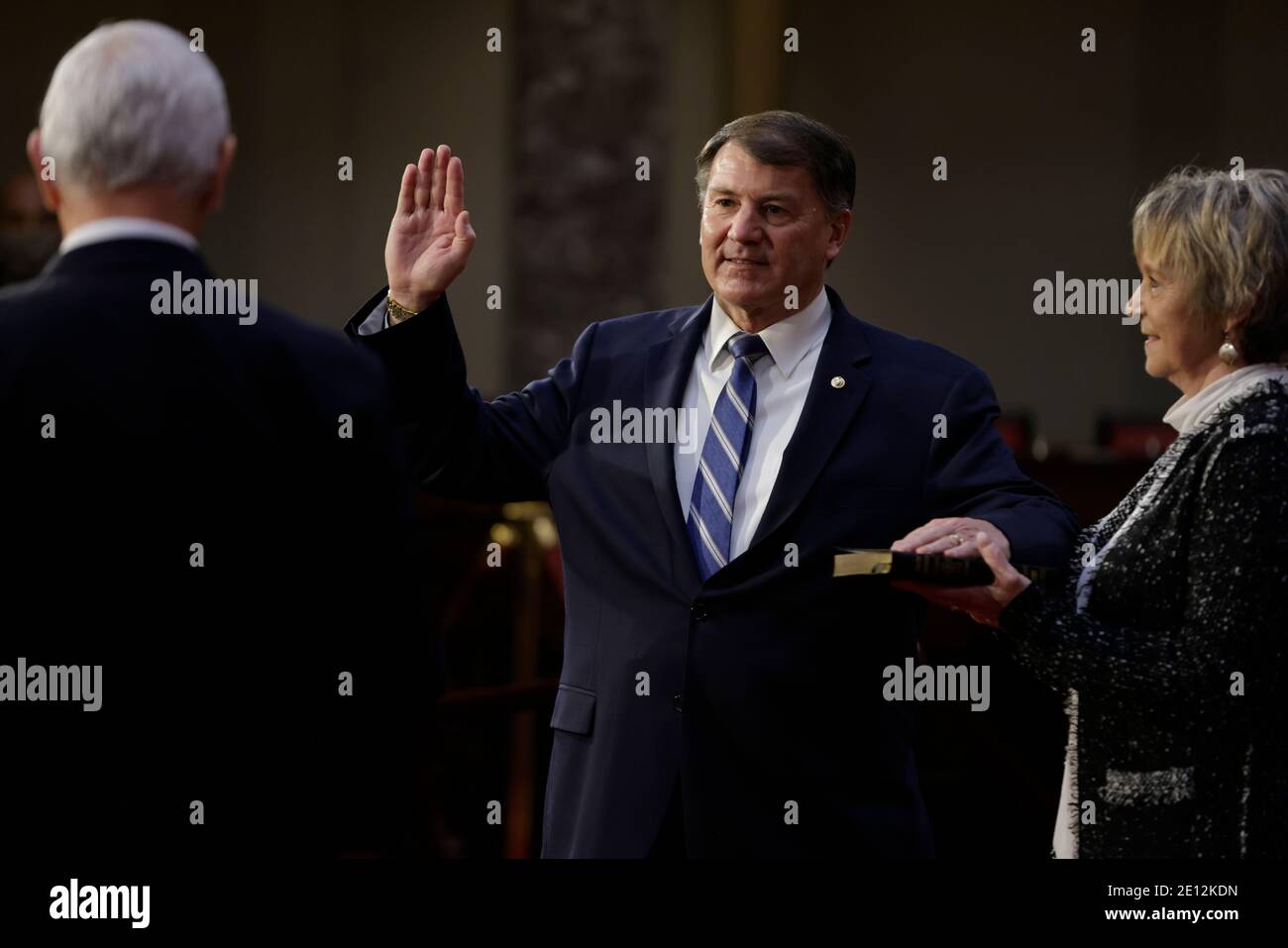 United States Senator Mike Rounds (Republican of South Dakota), center, is ceremoniously sworn-in by U.S. Vice President Mike Pence, left, at the U.S. Capitol in Washington, DC, U.S., on Sunday, Jan. 3, 2021. The 117th Congress begins today with the election of the speaker of the House and administration of the oath of office for lawmakers in both chambers, procedures that will be modified to account for Covid-19 precautions. Credit: Samuel Corum/Pool via CNP/MediaPunch Stock Photo