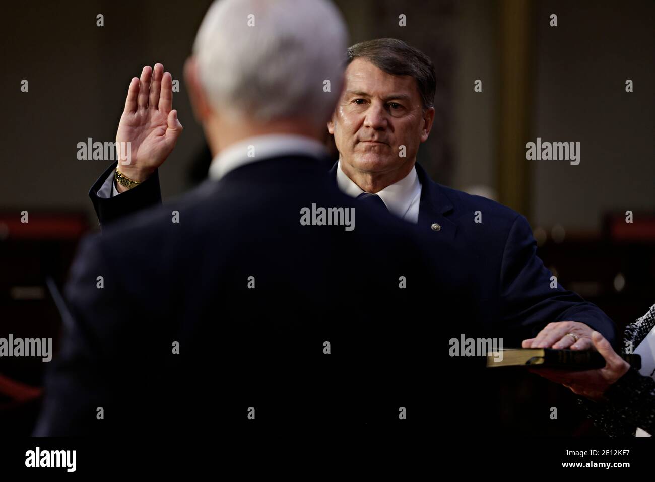 United States Senator Mike Rounds (Republican of South Dakota), center, is ceremoniously sworn-in by U.S. Vice President Mike Pence, left, at the U.S. Capitol in Washington, DC, U.S., on Sunday, Jan. 3, 2021. The 117th Congress begins today with the election of the speaker of the House and administration of the oath of office for lawmakers in both chambers, procedures that will be modified to account for Covid-19 precautions. Credit: Samuel Corum/Pool via CNP/MediaPunch Stock Photo