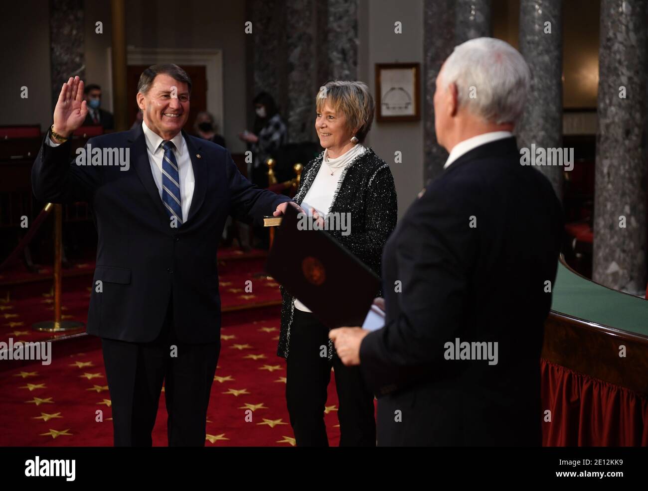 United States Senator Mike Rounds (Republican of South Dakota), participates in a mock swearing-in for the 117th Congress with Vice President Mike Pence, as his wife Jean Rounds holds a bible, in the Old Senate Chambers at the U.S. Capitol Building in Washington, DC on Sunday, January 3, 2021. Credit: Kevin Dietsch/Pool via CNP/MediaPunch Stock Photo