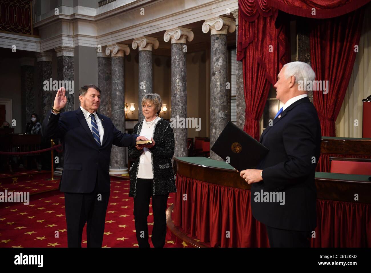 United States Senator Mike Rounds (Republican of South Dakota), participates in a mock swearing-in for the 117th Congress with Vice President Mike Pence, as his wife Jean Rounds holds a bible, in the Old Senate Chambers at the U.S. Capitol Building in Washington, DC on Sunday, January 3, 2021. Credit: Kevin Dietsch/Pool via CNP/MediaPunch Stock Photo