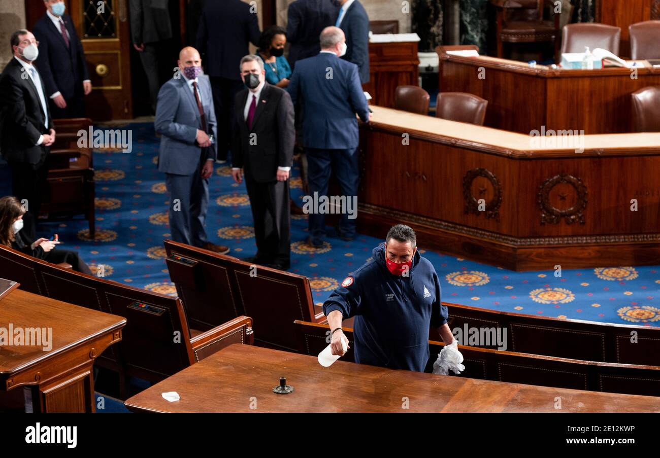 United States Capitol workers disinfect the House floor in the Capitol before members of the 117th Congress are sworn in on Sunday, January 3, 2021.Credit: Bill Clark/Pool via CNP /MediaPunch Stock Photo