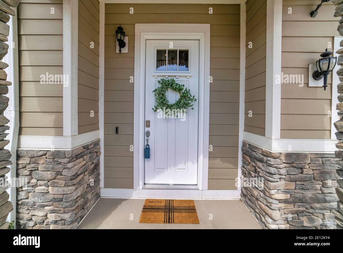 White wooden front door with glass panes and wreath at the facade of house  Stock Photo - Alamy