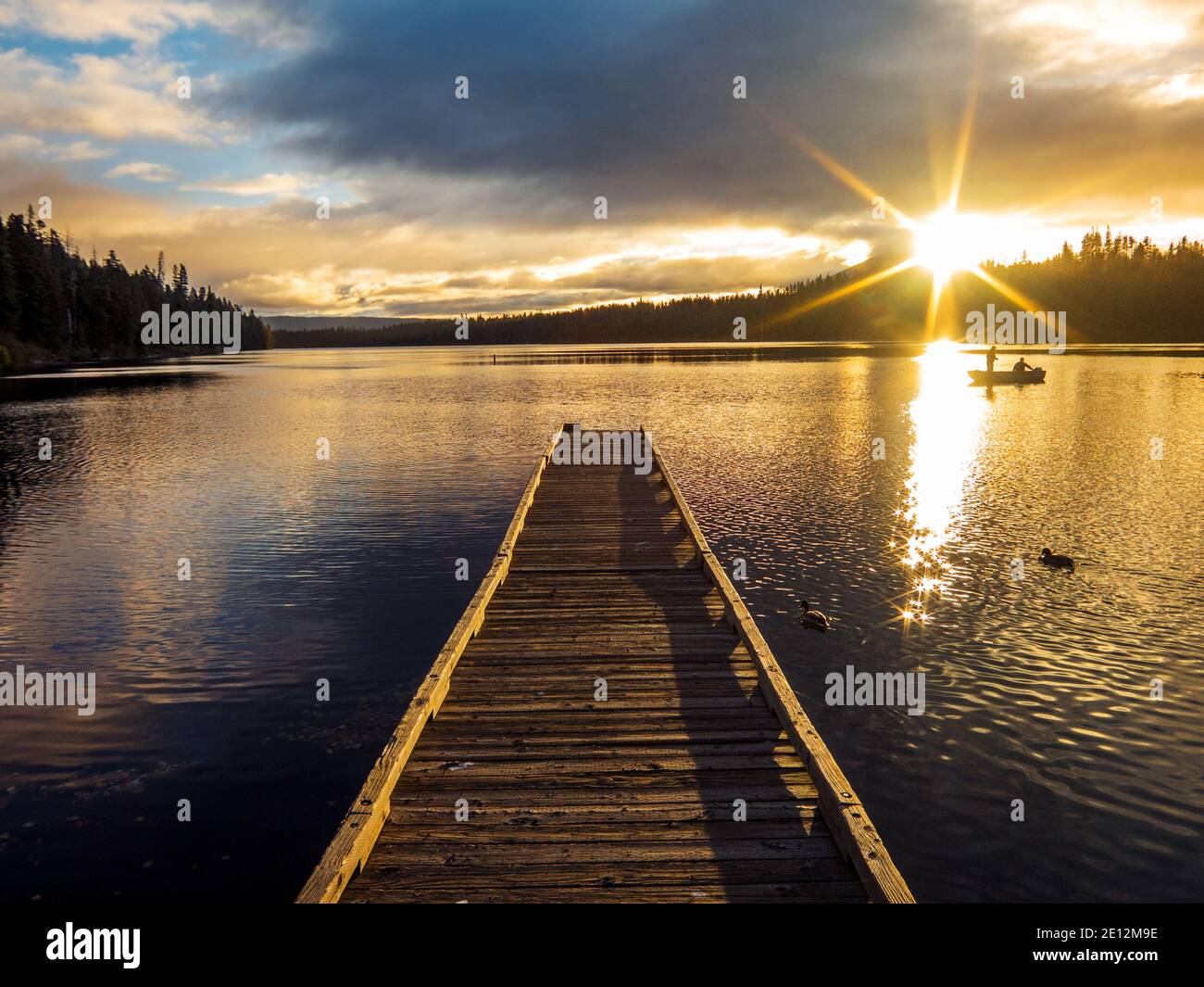 Two fishermen in a boat at sunrise on Suttle Lake, Oregon. Stock Photo