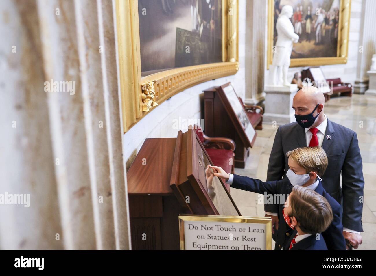 Washington, United States. 03rd Jan, 2021. Rep. Brian Mast (R-FL) walks with his sons Magnum and Maverick in the US Capitol on Sunday, January 3, 2021 in Washington, DC. Both chambers are holding rare Sunday sessions to open the new Congress on January 3, as the Constitution requires. Pool photo by Tasos Katopodis/UPI Credit: UPI/Alamy Live News Stock Photo