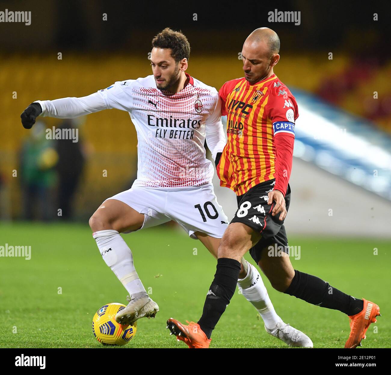 Benevento, Italy. 3rd Jan, 2021. AC Milan's Hakan Calhanoglu (L) vies with Benevento's Pasquale Schiattarella during a Serie A match between Benevento and AC Milan in Benevento, Italy, Jan. 3, 2021. Credit: Daniele Mascolo/Xinhua/Alamy Live News Stock Photo