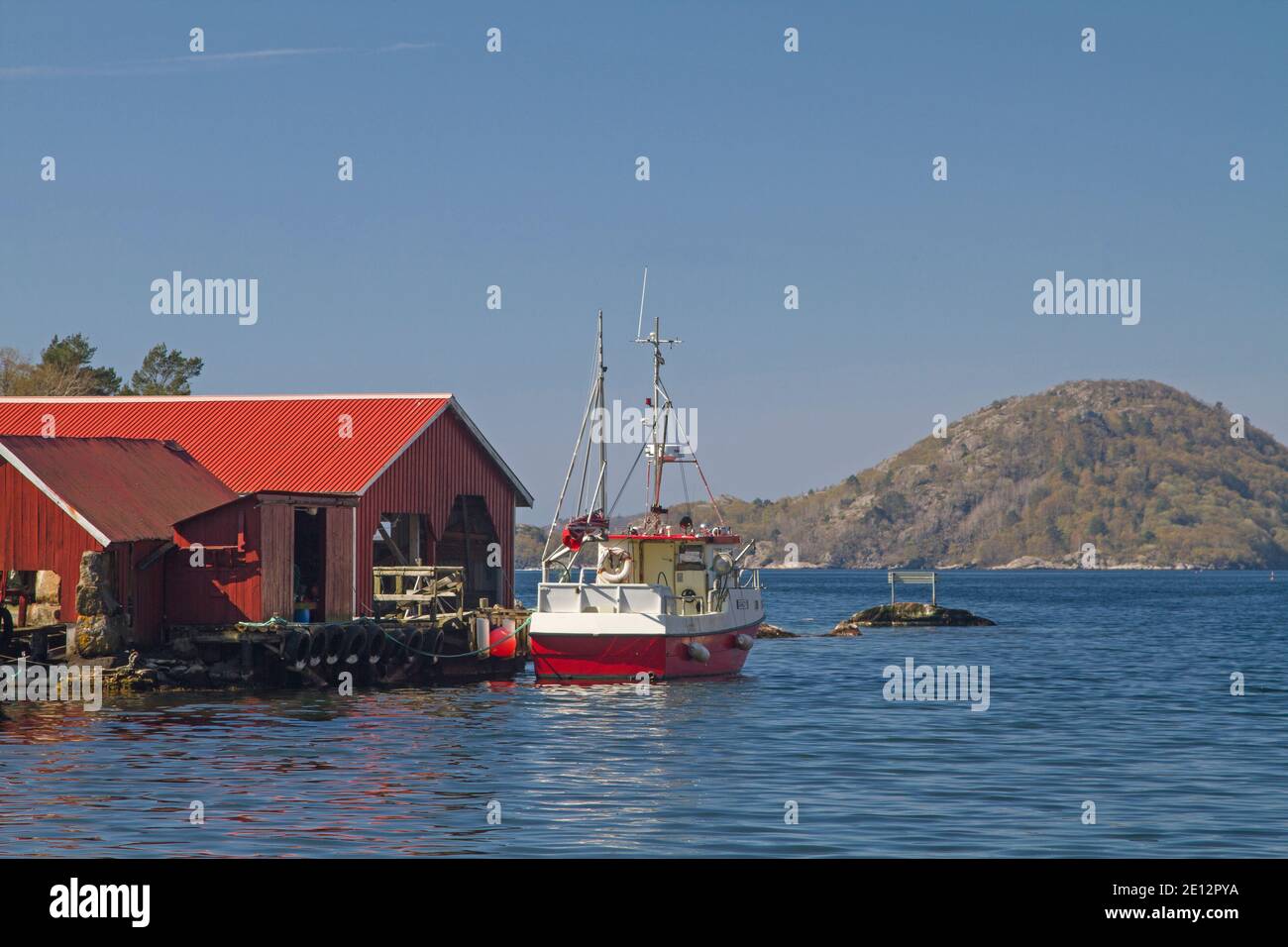 Boat Huts And Fishing Boats In Bjornevag An Idyllic Quiet Fishing Village On Spindsfjorden Stock Photo