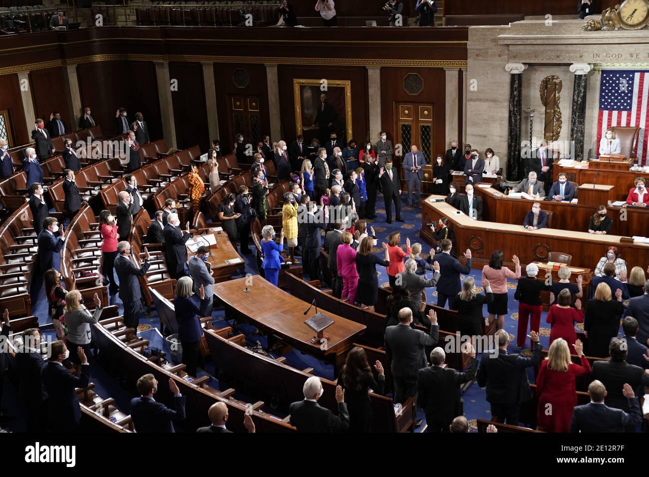 Washington, United States Of America. 03rd Jan, 2021. Democratic members of the United States House of Representatives take their oath of office administered by Speaker of the House Nancy Pelosi on the floor of the House Chamber during the first session of the 117th Congress on Capitol Hill in Washington, U.S., January 3, 2021. Credit: Erin Scott/Pool via CNP | usage worldwide Credit: dpa/Alamy Live News Stock Photo