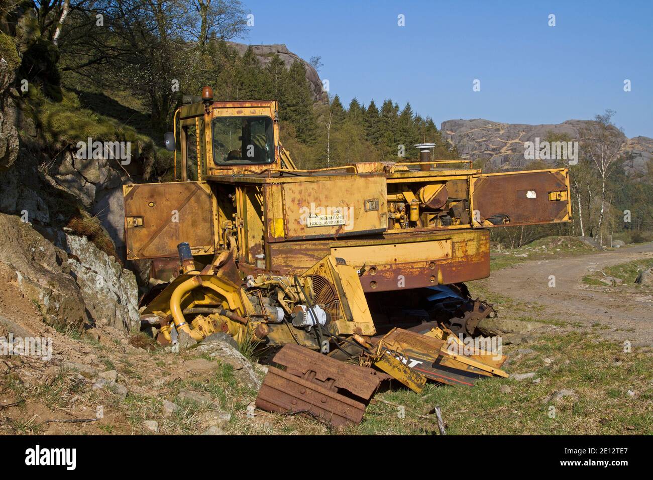Disposed - Discarded Construction Machine Parked In The Lonely Nature Of Norway Stock Photo