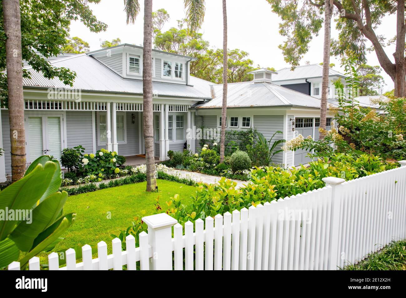 Australian hamptons style home with lush green and white domestic garden,Avalon Beach,Sydney
