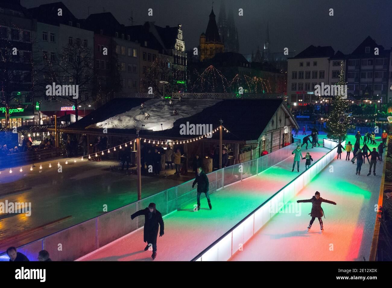 Ice Skating at the Christmas Market, or Weihnachtsmarkt in the historic Altstadt, or in the old city of Cologne. Stock Photo