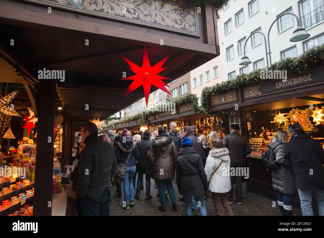 Christmas Market, or Weihnachtsmarkt in the historic Altstadt, or in the old city of Cologne below the gothic Old Town Hall. Stock Photo