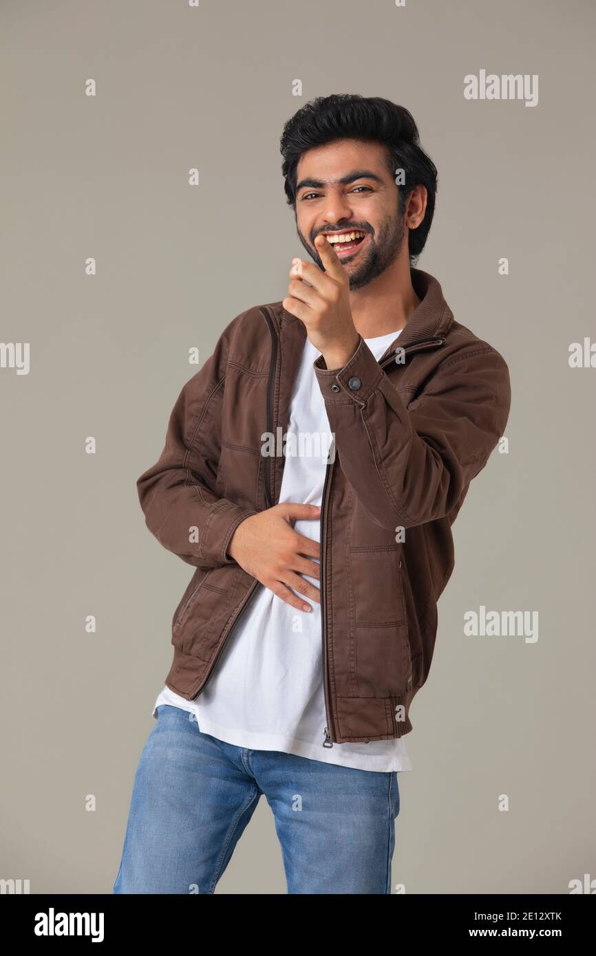 A HAPPY MAN LAUGHING HARD AND POINTING STRAUGHT Stock Photo