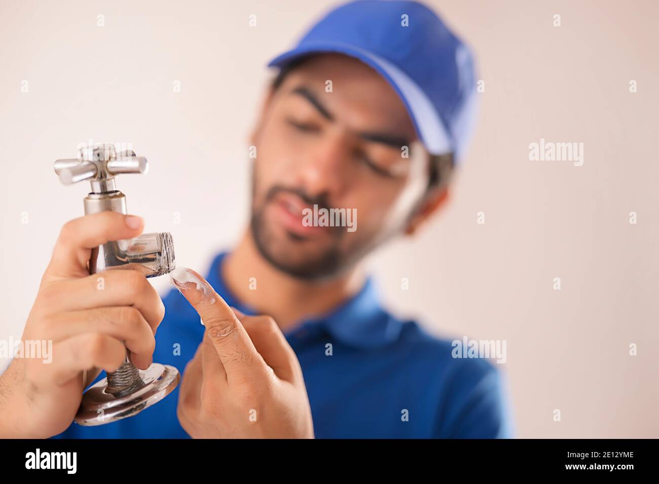 A BROKEN TAP BEING FIXED BY A PLUMBER Stock Photo
