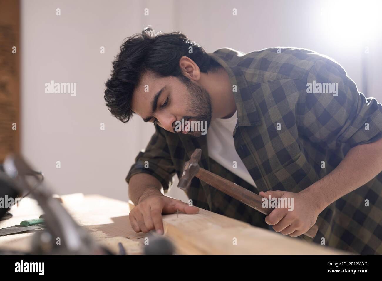 A CARPENTER USING HAMMER TO FIX NAIL ON WOOD BLOCKS Stock Photo Alamy
