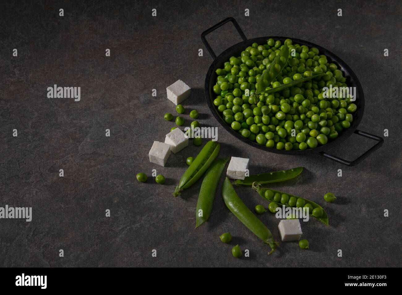 A bowl of fresh peas with some cottage cheese or paneer pieces Stock Photo