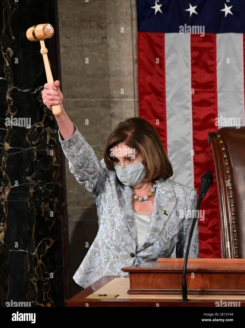 (210104) -- WASHINGTON, D.C., Jan. 4, 2021 (Xinhua) -- U.S. House Speaker Nancy Pelosi waves a gavel during the first session of the 117th U.S. Congress in the House Chamber on Capitol Hill in Washington, DC, the United States, Jan. 3, 2021. Democratic Congresswoman Nancy Pelosi of California was reelected on Sunday as speaker of the U.S. House of Representatives, where her party has a narrow majority. (Erin Scott/Pool via Xinhua) Stock Photo