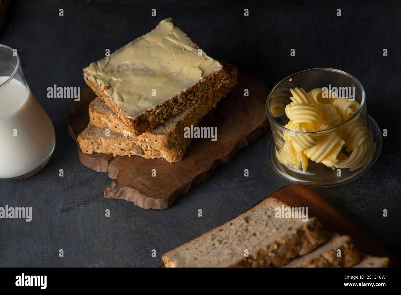 Top view of Bread and butter with a glass of milk Stock Photo