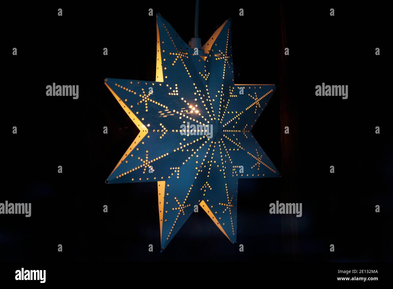 Christmas star from the side hanging in window Stock Photo
