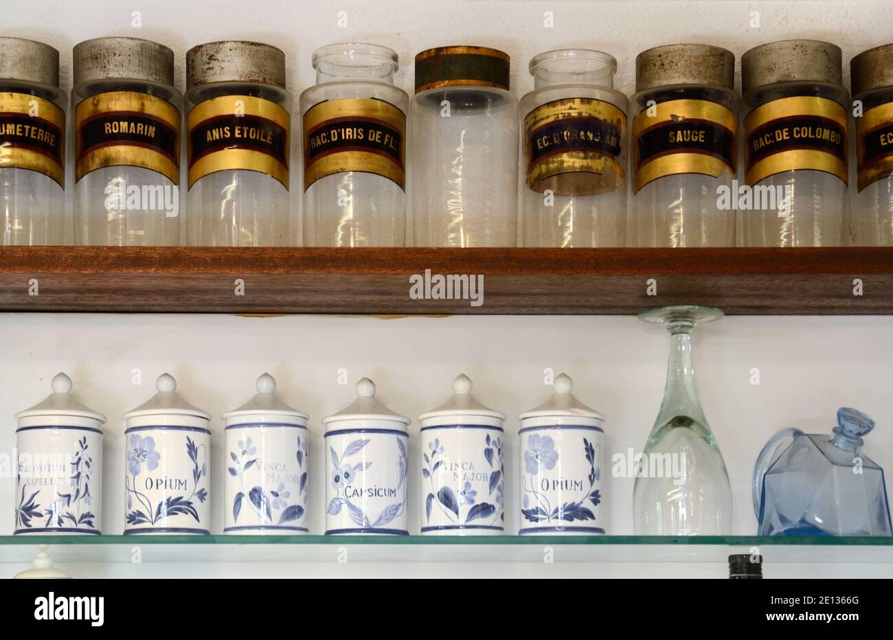 Display of Old or Vintage Apothecary Jars, Medicinal Jars, Drug Jars or Herb Jars incl. Storage Jars for Opium & Capsicum on Shelves in Kitchen Stock Photo