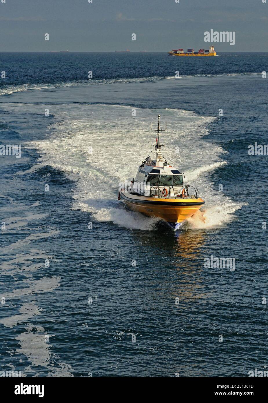 north sea, netherlands -  2011-05-12: the pilot launch orion speeding to an inbound containership for pilot embarkation at maasgeul / maasmond --  [cr Stock Photo