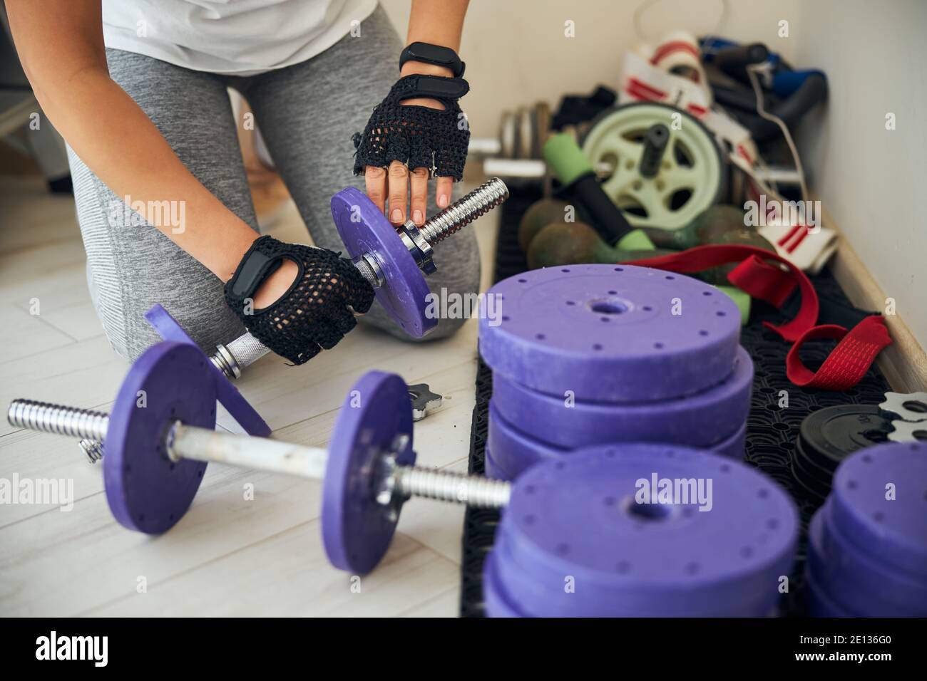 Female bodybuilder preparing for the weight-lifting workout Stock Photo