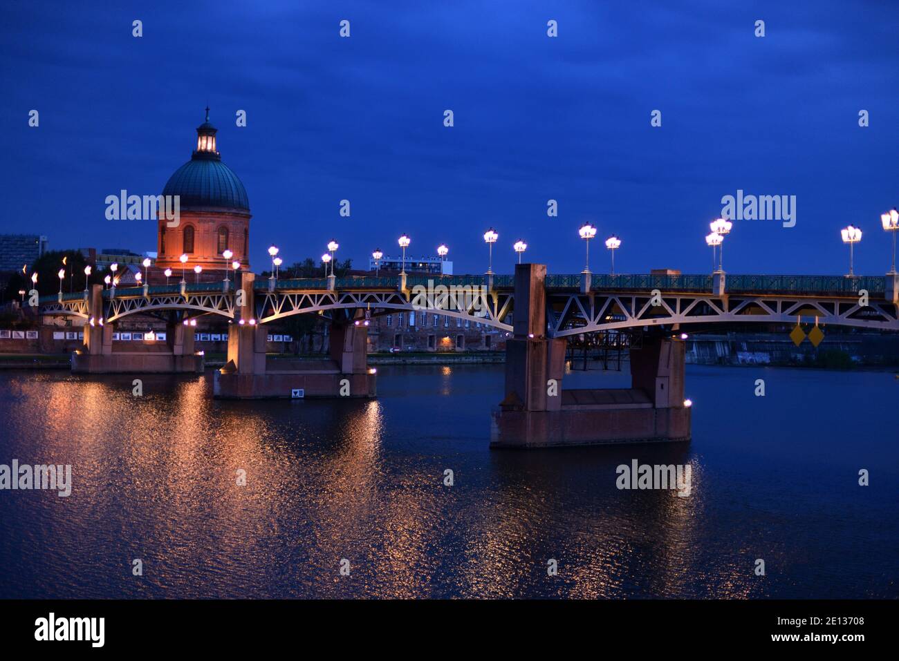 Townscape or Skyline of Toulouse at Night or Dusk with Baroque Dome of Saint Joseph Chapel Grave & St Pierre Bridge over Garonne River Toulouse France Stock Photo