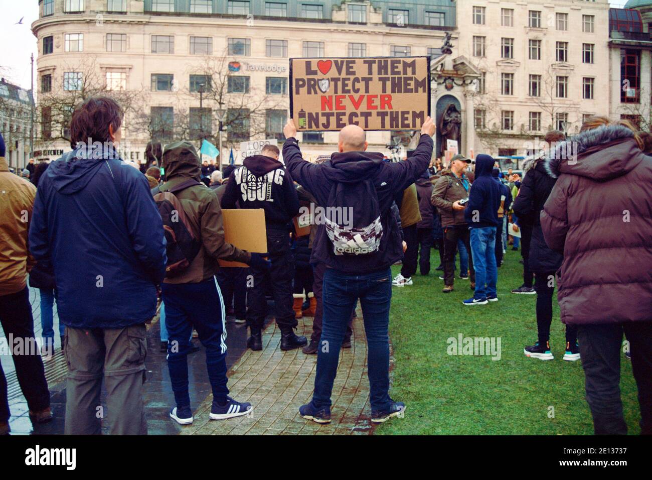 Manchester, UK - 5 December 2020: A man took part in a protest in Piccadilly Gardens holding up an anti-vaccine slogan Stock Photo