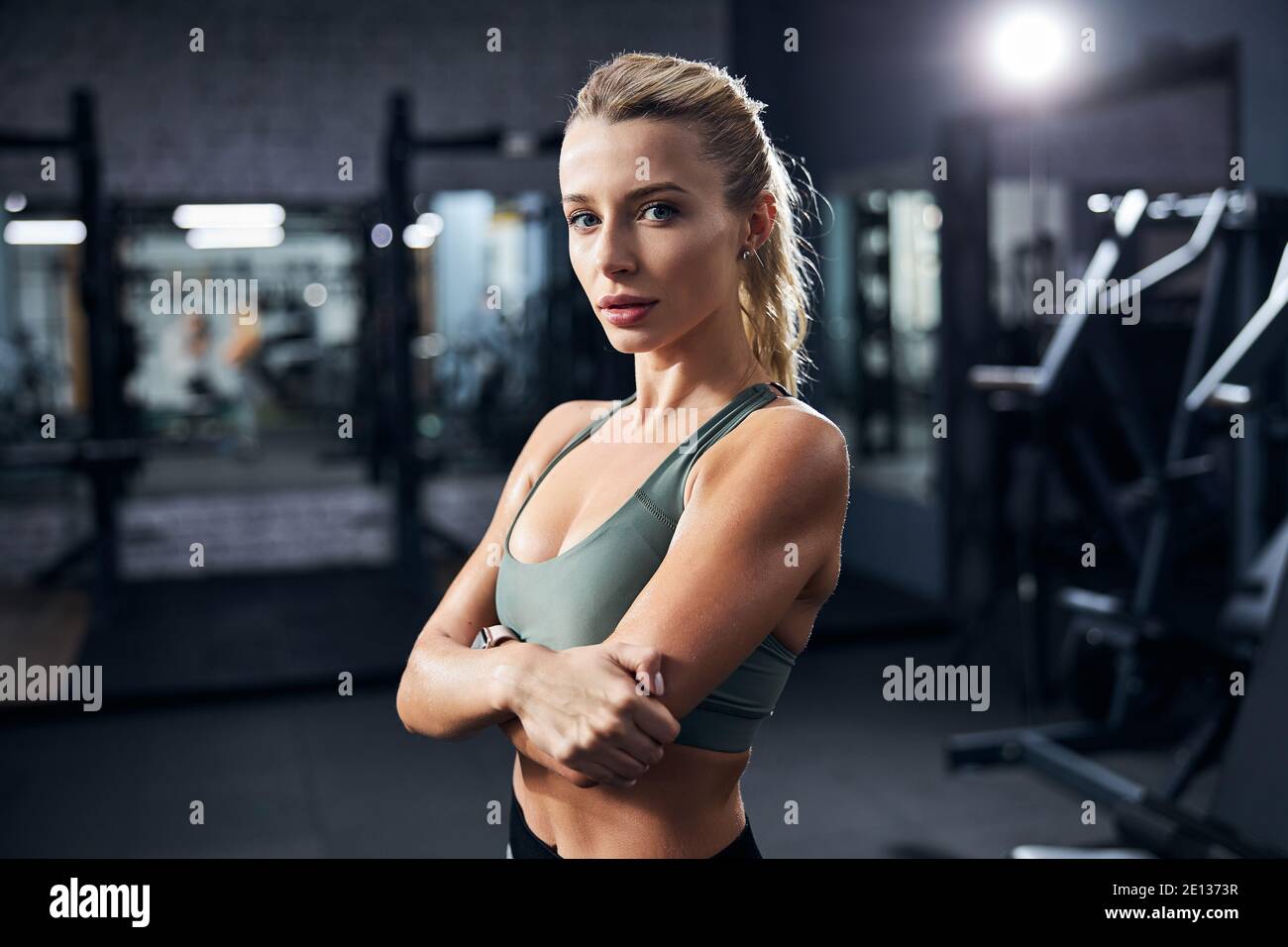 Interested sportswoman with arms across her chest Stock Photo Alamy